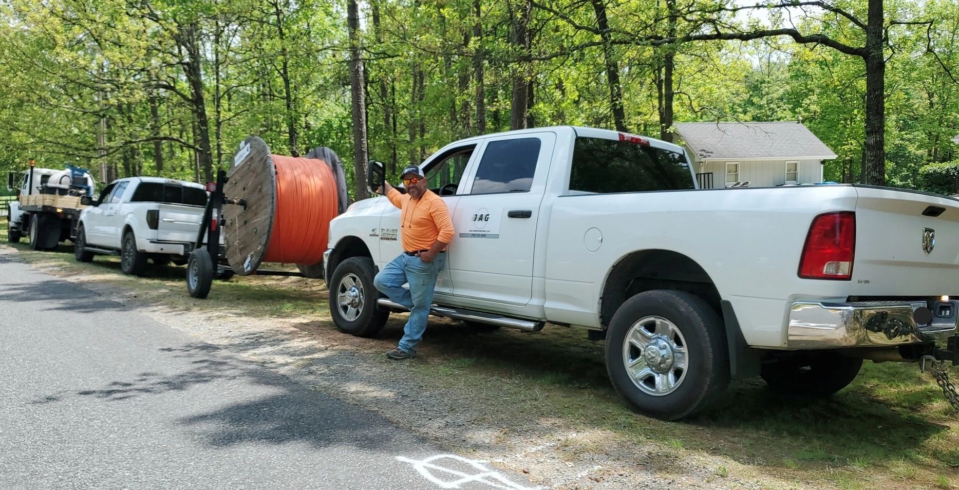 Man leaning on truck near forest road