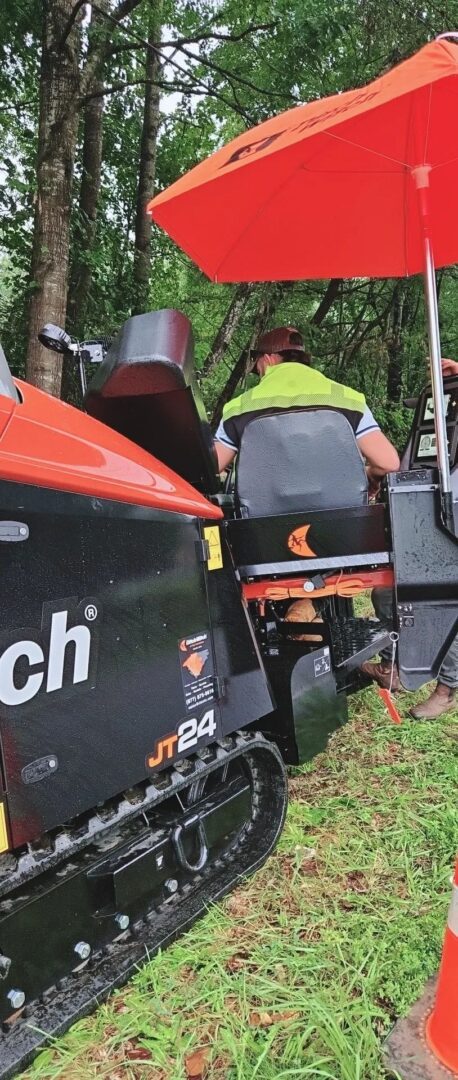 Construction worker operating drilling machine
